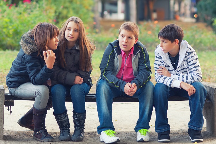 Young teenagers sitting and talking