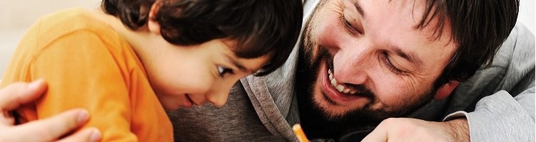 A father and young son laughing